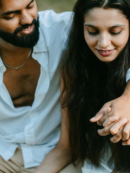 A close-up, intimate shot focusing on the couple's hands and their gentle expressions. It's a tender moment that speaks volumes.