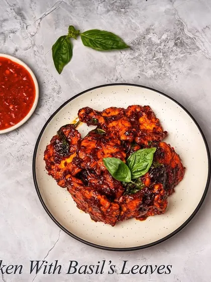 Another look at our Crispy Chicken with Basil's Leaves, served with a spicy dipping sauce. The dish combines a satisfying crunch with a spicy and herbaceous flavour.
