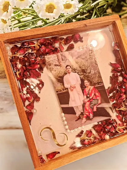 Varmala preserved in a beautiful wooden shadow box frame for a lovely couple. A timeless way to display wedding memories.