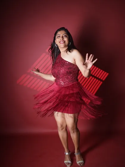A duplicate of another image, this captures the joyful, twirling motion of the red fringe dress, reflecting the high energy I bring to the dance floor.
