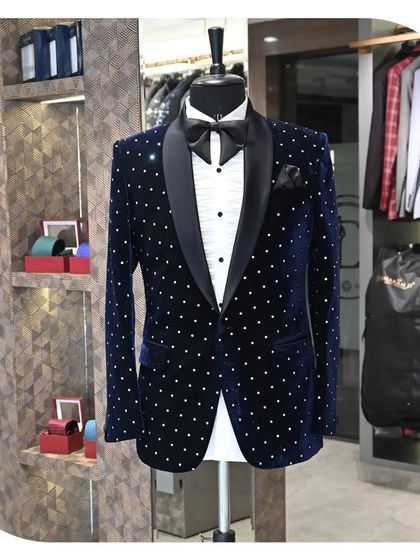 A blue velvet tuxedo jacket with a polka dot pattern and a black satin lapel. This is a fun yet elegant option for a reception or cocktail party.