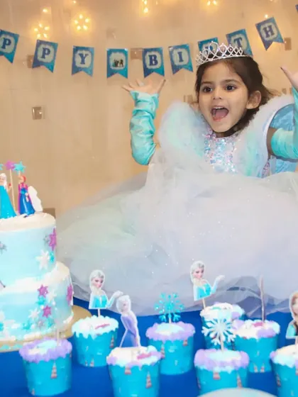 The pure excitement of a birthday girl at her Frozen-themed party. I capture the energy and joy of children's parties, including all the details from the cake to the expressions.