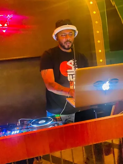 A shot of me working the laptop and mixer during a busy Friday night gig at my residency.