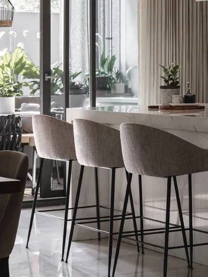 The breakfast bar is a perfect spot to start the day, with natural light streaming in from the adjacent deck.