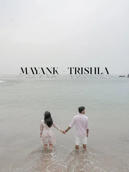 A powerful and serene image of the couple holding hands as they stand in the ocean, looking out at the horizon. This pre-wedding photo symbolizes them stepping into their future together.