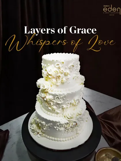 For timeless celebrations, I craft pieces like this elegant three-tier white wedding cake. The intricate, hand-piped floral details and classic rosettes create a look of pure grace and sophistication.