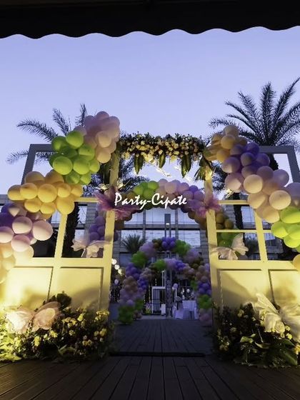 The entrance to this fairy party was designed to feel like walking through a magical gate. A large balloon arch in pastel colors, floral arrangements, and a giant butterfly prop set the tone for the enchantment inside.