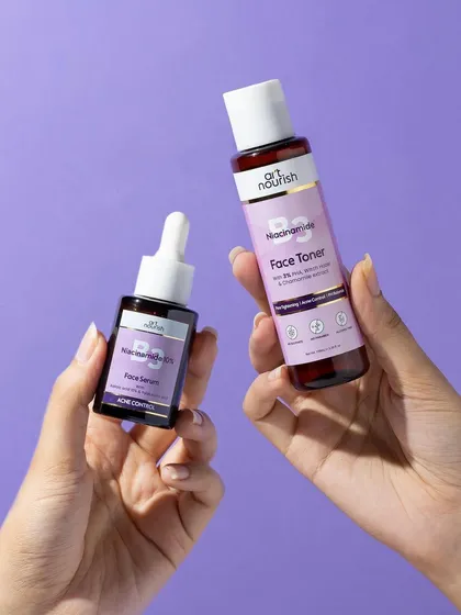 This hand model shot shows two products from the same line, suggesting a routine. The clean composition and purple background create a cohesive and aesthetically pleasing image.