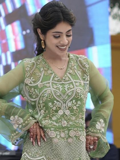 A close-up of a beautiful performer during the family dance at the mehendi ceremony.