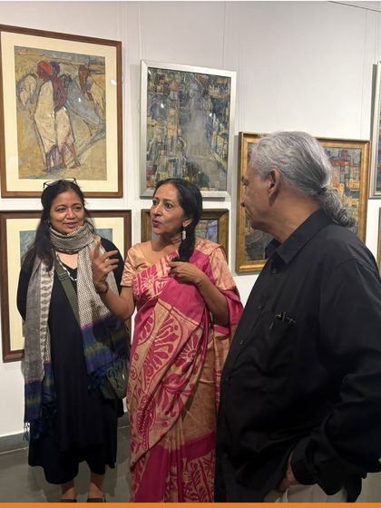 Curator Rasna Bhushan in conversation with guests at the preview of the Vidya Bhushan exhibition. The curator's role is essential in shaping the narrative of a show.
