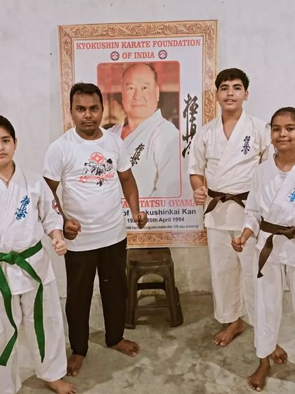 A step towards the black belt. I am here with my senior students who have just upgraded their belts. A green belt and two brown belts.