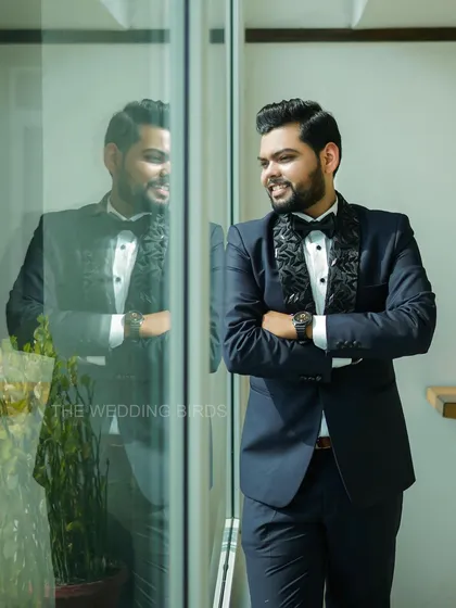 A dapper groom ready for his engagement night. This portrait captures his confident smile and sharp style, with his reflection adding a cool, modern touch.