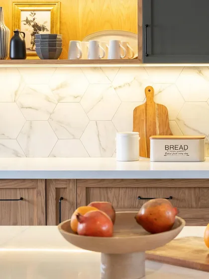 A detail shot of the open shelving and hexagon backsplash. Styling shelves with a mix of practical items and decorative objects makes them both useful and beautiful.