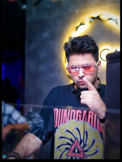 Not the villain you think, but the anti-hero you need. A moment of thought behind the decks, contemplating the next track to drop.