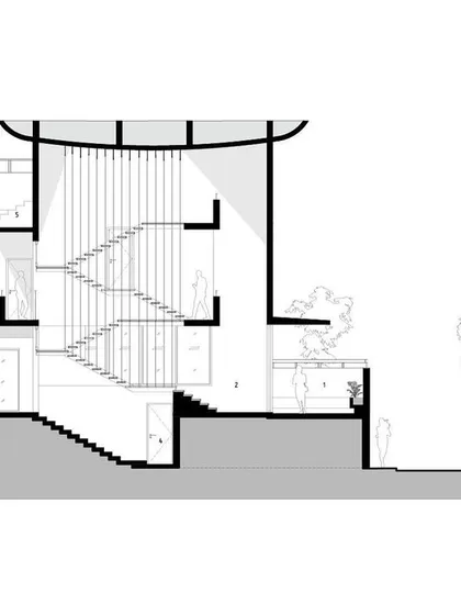 A sectional drawing of the Nairy Residence. This drawing reveals the core design concept, showing how the main staircase acts as a central spine connecting double and triple-height volumes, creating a complex and interconnected interior world.