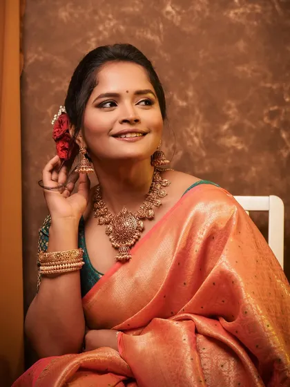A close-up of Sharayu Date, showing the intricate temple jewellery that complements her traditional silk saree.