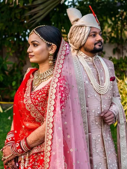 A classic back-to-back pose. This editorial-style portrait is elegant and timeless, highlighting the couple's stunning wedding attire.