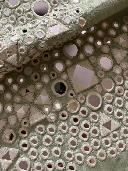 A macro shot of the mirrorwork, highlighting the precision of the embroidery.