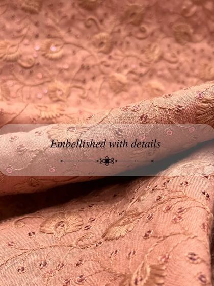 Our embroidered fabrics, like this delicate peach-on-peach design, are perfect for creating elegant and festive outfits.