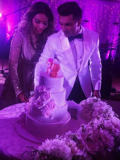 This was the first celebrity wedding cake I ever made, for Bipasha Basu and Karan Singh Grover. It was a beautiful pearl white cake with a lace effect, and because they called it their "Monkey Wedding," we created custom monkey bride and groom toppers.