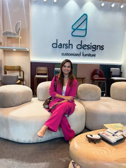 It was a pleasure to have visitors stop by our booth to see our work. Here, a guest tries out our curved, modular sofa, a centerpiece of our display.