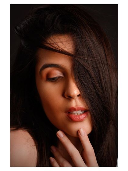 A close-up beauty portrait with a soft, dreamy feel. The focus is on the model's expression and the gentle lighting, creating a timeless and romantic image.