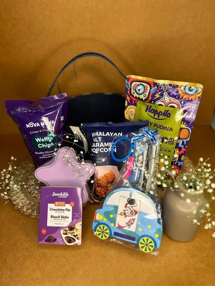Here is another fun option for a little brother. This hamper is packed with snacks like waffle chips and popcorn, along with a star-shaped light and a cute astronaut-themed pouch.