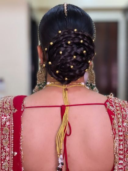 For a touch of modern glam, I created this intricate braided bun and studded it with tiny gold beads. This style looks stunning with traditional Indian bridal wear.
