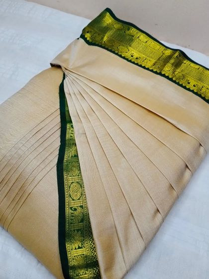 Believe me when I say you can drape a saree in less than five minutes. This beige and green saree is a perfect example of ready-to-wear elegance.