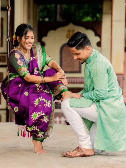 A charming and romantic gesture. His kneeling pose adds a touch of chivalry and playfulness to this traditional Maharashtrian themed shoot.
