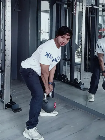 Demonstrating a kettlebell deadlift, a fantastic compound exercise for building posterior chain strength, including the glutes, hamstrings, and back.