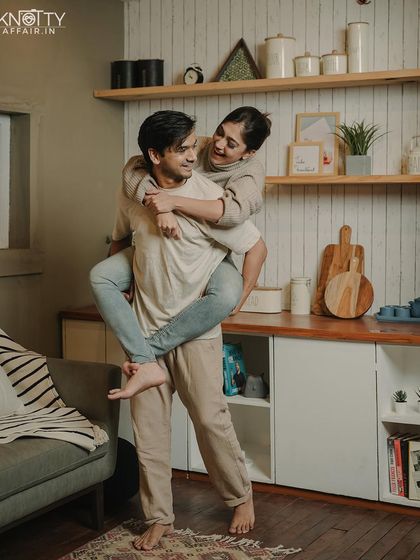 A fun piggyback ride in the kitchen. These candid, happy moments are what make an at-home pre-wedding shoot feel so genuine and personal.