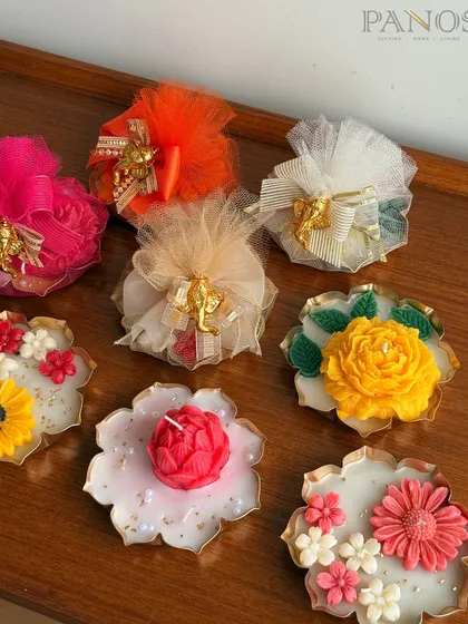 Our collection of floral-inspired floating candles, shown with their charming potli gift packaging. These are perfect for adding charm to festive corners or as thoughtful return favors.