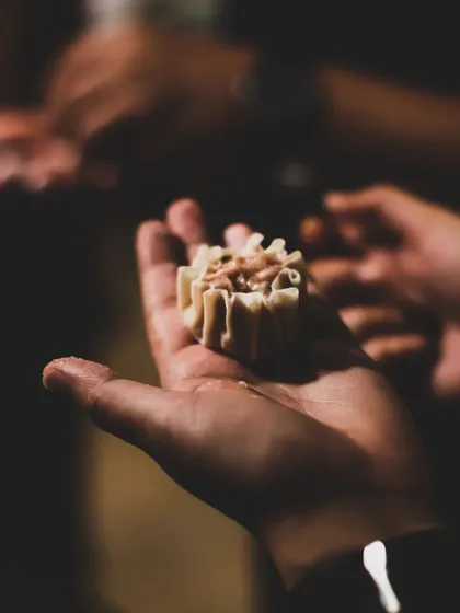 A perfectly crafted dumpling, ready to be steamed. It's these small, satisfying moments that make our cooking classes so rewarding.