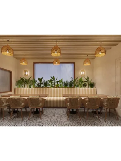 A comfortable banquette seating area lined with plants, creating a fresh and relaxing dining spot.