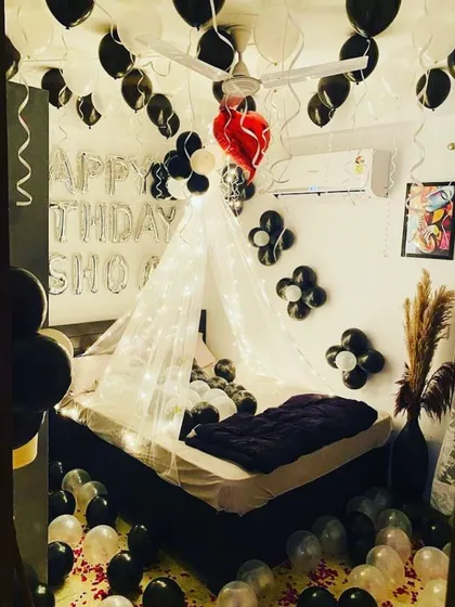 I offer a variety of decoration themes, like this stylish black, white, and red setup. It includes a fairy-lit cabana, balloons covering the ceiling, and personalized "Happy Birthday" messages to make the celebration uniquely yours.