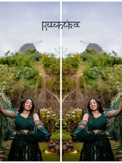 A creative, mirrored portrait of the bride in a lush green setting, highlighting her beautiful green lehenga.