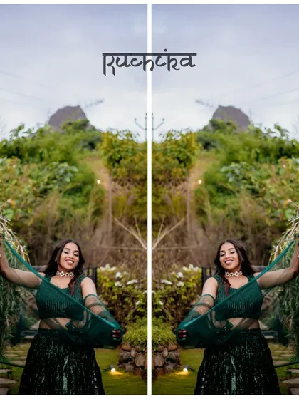 A creative, mirrored portrait of the bride in a lush green setting, highlighting her beautiful green lehenga.