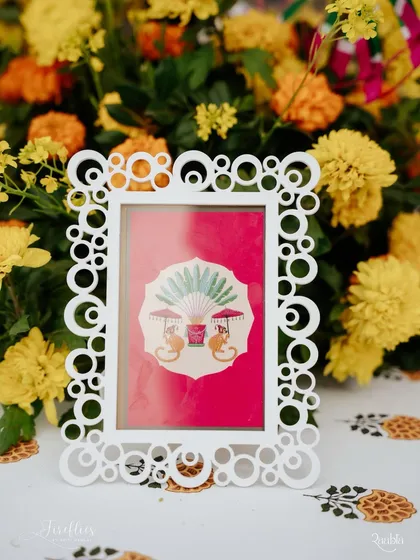 A custom-printed card in a whimsical frame, used as a table centerpiece. The playful monkey illustration added a touch of fun to the Mela decor.