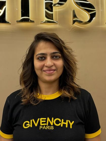 A smiling client with her new hair color and style. The look is fresh, modern, and perfectly suits her personality.