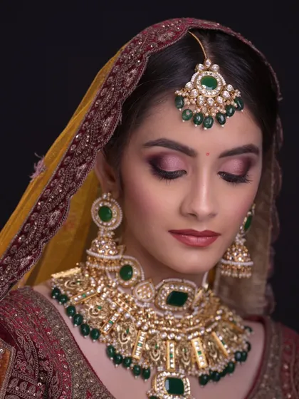 Eyes closed to showcase the beautiful blend of pink and gold on the eyelids.