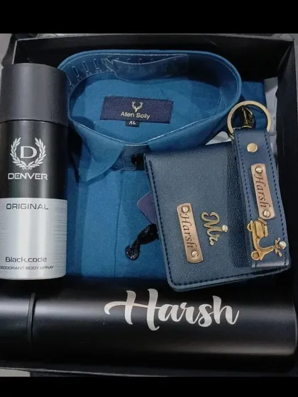 A classic blue and black gift hamper with a personalized temperature bottle, a matching wallet and keychain set, a shirt, and deodorant.