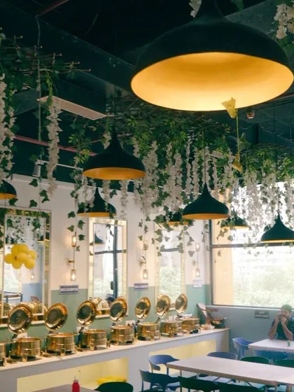 A view of the buffet line from a distance, showing how it is integrated into the overall design of the restaurant.