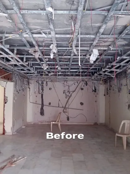 The 'Before' shot of the multi-purpose living room, showing exposed ceiling framework and bare walls. This raw space was a blank slate for us to create a completely new environment tailored to the client's hobbies and lifestyle.