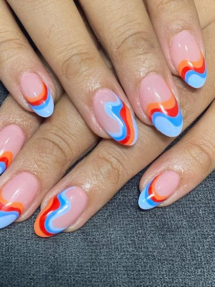 A full view of the colorful retro swirl nails. This design is all about good vibes.