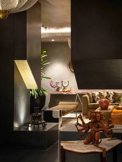 A detail from the formal living room, showcasing a multi-armed deity sculpture. This space is a curated gallery of art and bespoke furniture, designed to be both luxurious and evocative.