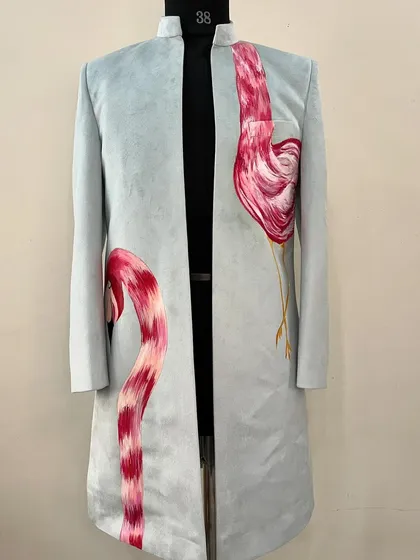 Be a flamingo in a flock of pigeons. I painted these elegant flamingos on a light blue sherwani, using their graceful curves to create a unique and eye-catching design.