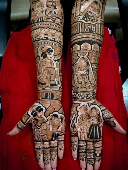 This design captures multiple wedding moments, including the varmala ceremony and the pheras around the sacred fire, creating a complete wedding album on the arms.