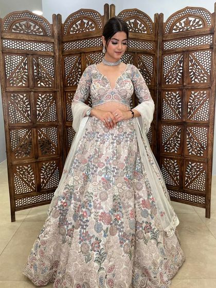 The model looks serene in this beautiful floral embroidered lehenga, showcasing its elegant design and full-sleeve blouse.