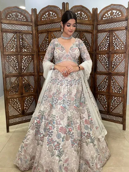 The intricate threadwork in pastel shades gives this lehenga a very delicate and feminine feel.